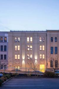a large building with lights on in front of it at Cumberland Street deluxe apartment No1 in Dunedin