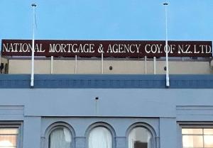 a sign on the top of a building at Cumberland Street deluxe apartment No1 in Dunedin