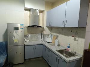 A kitchen or kitchenette at Beijing Oriental Tulip Building