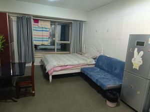 A bed or beds in a room at Beijing Oriental Tulip Building