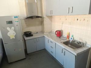 A kitchen or kitchenette at Beijing Oriental Tulip Building