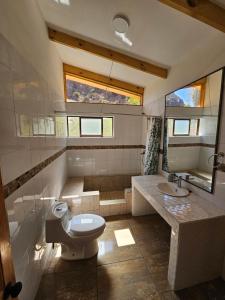 a bathroom with a toilet and a sink at La Estancia del Molle in El Molle +42 photos