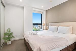 a bedroom with a large bed and a window at Swainson on Balfours in Adelaide +35 photos