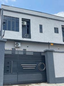 a building with a large black garage door at Extravaganza Stay in Lagos