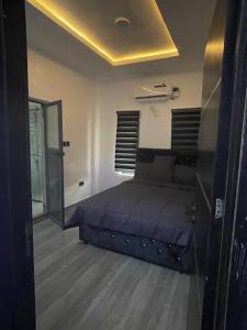 a bedroom with a bed and a mirror at Extravaganza Stay in Lagos