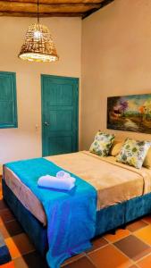 En eller flere senge i et værelse på Hotel Boutique Campestre El Ensueño