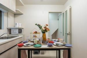 a kitchen with a table with dishes on it at 2mins walk to chidoribashi 12mins walk to nishikuzyou USJ Dotonbori nanba in Osaka