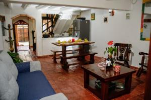 a living room with a blue couch and a table at La CASITA BOUTIQUE VILLA DE LEYVA in Villa de Leyva