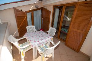 a table and chairs on the balcony of a house at Guesthouse Villa Lena in Premantura