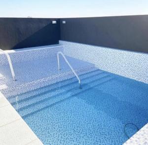 a large swimming pool with a blue tile floor at LA RIVIERA Copahue - CON COCHERA in Villa María
