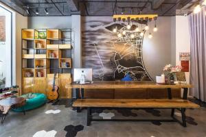 a room with a desk and a painting on the wall at OPOX Nha Trang in Nha Trang