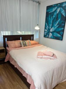 a bedroom with a bed with two towels on it at Bondi Stylish Bedroom Close to the Beach in Sydney