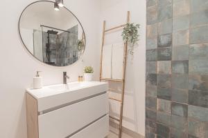 a bathroom with a white sink and a mirror at Stylish apartment in the heart of Lisbon in Lisbon