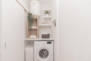 a laundry room with a washer and dryer at Stylish apartment in the heart of Lisbon in Lisbon