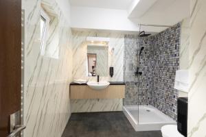 a bathroom with a sink and a shower at Apart Hotel Bonjour Cluj in Cluj-Napoca