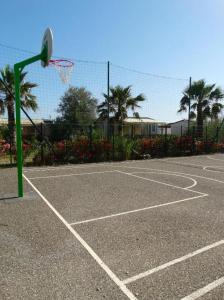 a basketball court with a hoop and a basket at Mobile home in Sérignan +2 photos