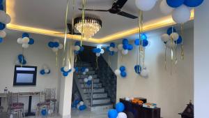 a bunch of blue and white balloons hanging from a ceiling at Hotel om namami in Rishīkesh