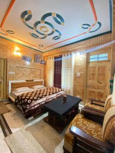 a bedroom with two beds and a table in it at Janvi Homestay in Kalpa