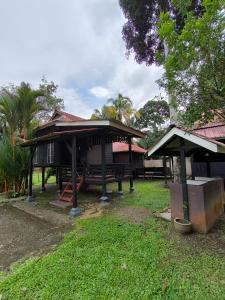 a building with a pavilion in a yard with trees at Hotel O Bogor near Taman Safari formerly Hotel Rudian 1 in Bogor