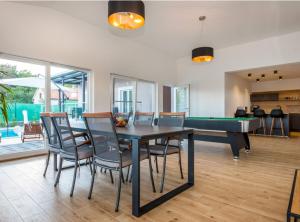 a dining room with a ping pong table and chairs at Villa Branka in Drniš