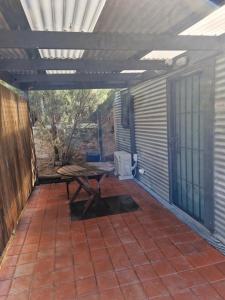 a patio with a picnic table on a patio at The Bullock & Bridle Retreat at 58 in Mintaro