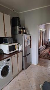 a kitchen with a refrigerator and a microwave at Pensjonat Stara Szkoła in Piaseczno +13 photos