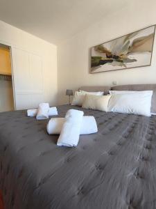 a large bed with white pillows on top of it at Downtown Luxury Apartment in Rhodes Town