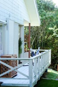 a porch with a white railing on a house at Marine Villa Ilio in Sumoto