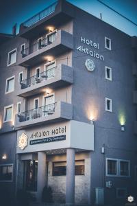 a hotel at night with a sign in front of it at Aktaion Hotel in Igoumenitsa