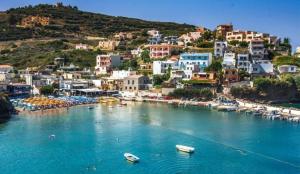 a view of a beach with boats in the water at Melina Stone Villa in Roumelí