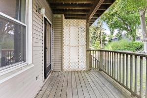 a wooden porch of a house with a window at Spacious apartments near Ashmont - Evonify Stays in Boston