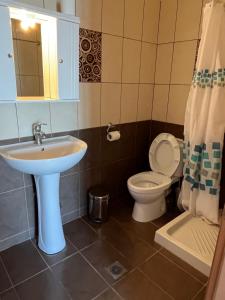 a bathroom with a sink and a toilet at Studios-Heaven in Chrysi Ammoudia