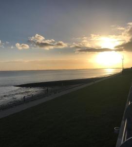 a view of the beach at sunset at Nordsee in Wilhelmshaven
