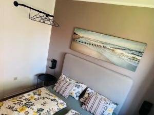 a bedroom with a bed and a painting on the wall at Nordsee in Wilhelmshaven