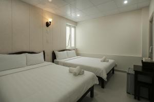 Postel nebo postele na pokoji v ubytování LAM ANH Hotel