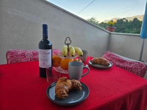 a table with a bottle of wine and a basket of fruit at casa caberlon in Malcesine +15 photos