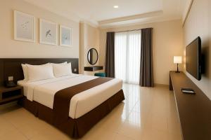 A television and/or entertainment centre at The Bellezza Hotel Suites