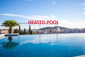 a heated pool with a sign that reads heated pool at Art Hotel in Split