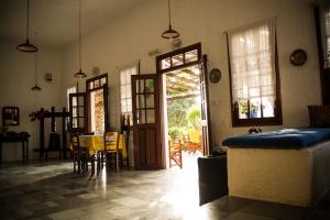 a room with a table and chairs and a door at Vagia Traditional, Aegina Island in Vaia