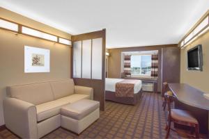 a hotel room with a bed and a desk at Microtel Inn & Suites by Wyndham Harrisonburg in Harrisonburg