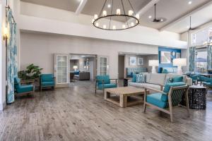 a lobby with blue chairs and a couch at Hampton Inn & Suites Venice Bayside South Sarasota in Venice