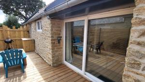 a large sliding glass door on a deck at KerLudi Le Ptit St Roch, gîte de charme 5km de la mer in Ploudalmézeau