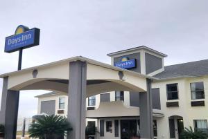 a hotel with a sign on top of it at Days Inn by Wyndham Lafayette Scott in Lafayette