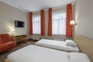 Postel nebo postele na pokoji v ubytování Rija Domus Hotel