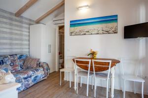a living room with a table and a couch at La Mimosa Camping in Fano
