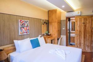 a bedroom with a white bed and a bathroom at GOYA hotel in Chiang Mai +53 photos