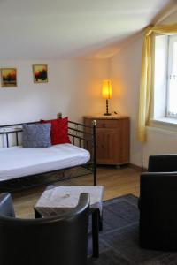 a room with a bed and a table and a lamp at Villa Silvanus in Ebensee