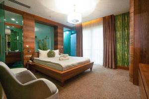 a bedroom with a bed and two chairs in it at Golden Pars Hotel in Bursa +39 photos