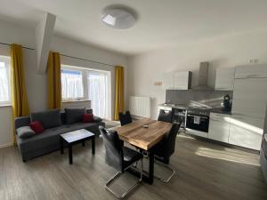 a living room with a couch and a table with chairs at Race & Rest Apartments in Baar +34 photos