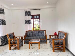 a living room with a couch and two chairs at The Off Road Homestay in Kandy +15 photos